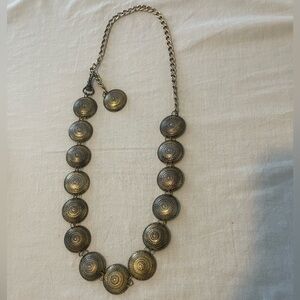 Long, circular, gold metal necklace